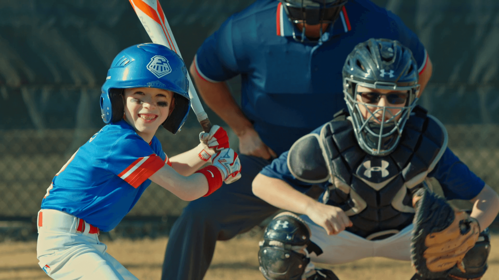 kid smiling and playing baseball